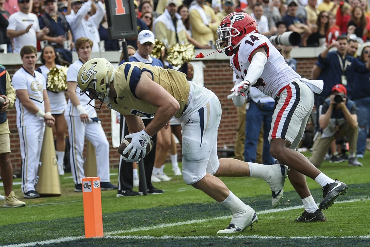 Nov 30, 2019; Atlanta, GA, USA; Georgia Tech Yellow Jackets tight end Tyler Davis (9) scores a touchdown behind Georgia Bulldogs defensive back DJ Daniel (14) during the first half at Bobby Dodd Stadium. Mandatory Credit: Dale Zanine-USA TODAY Sports